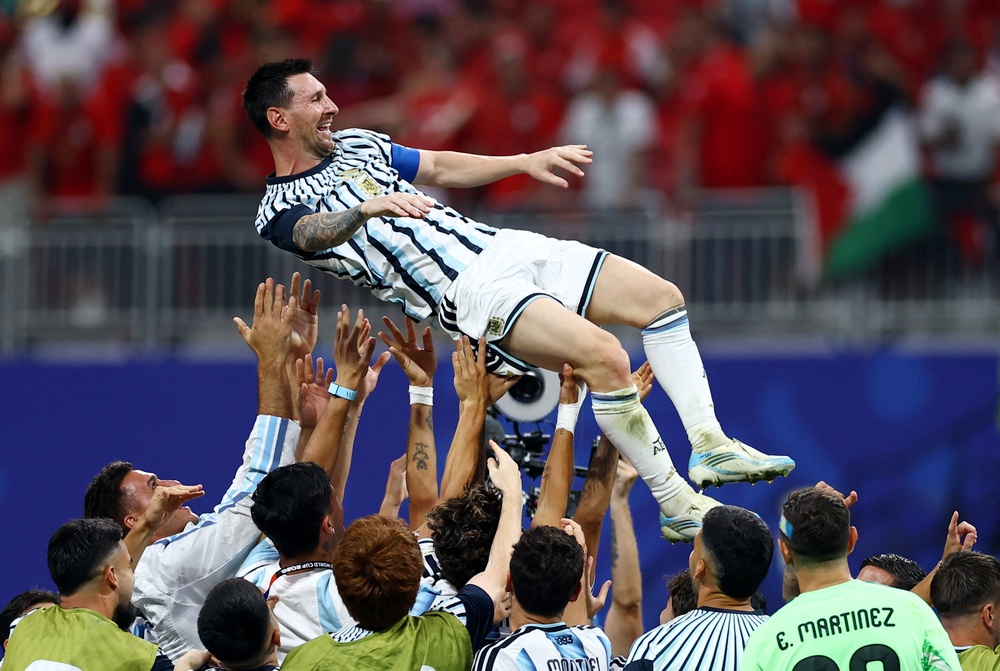 by joy as his teammates tossed him into the air (Reuters)