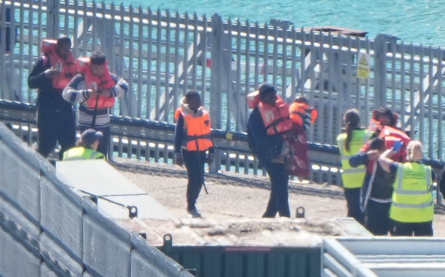 A group of people thought to be migrants are brought in to the Border Security Command compound in Dover, Kent (Gareth Fuller/PA) (PA Wire)