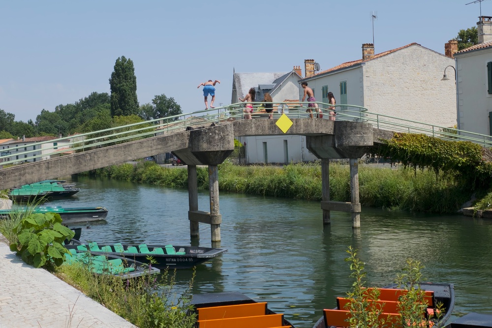 Local children jumping off a bridge at Coulon in France (Anna Richards)