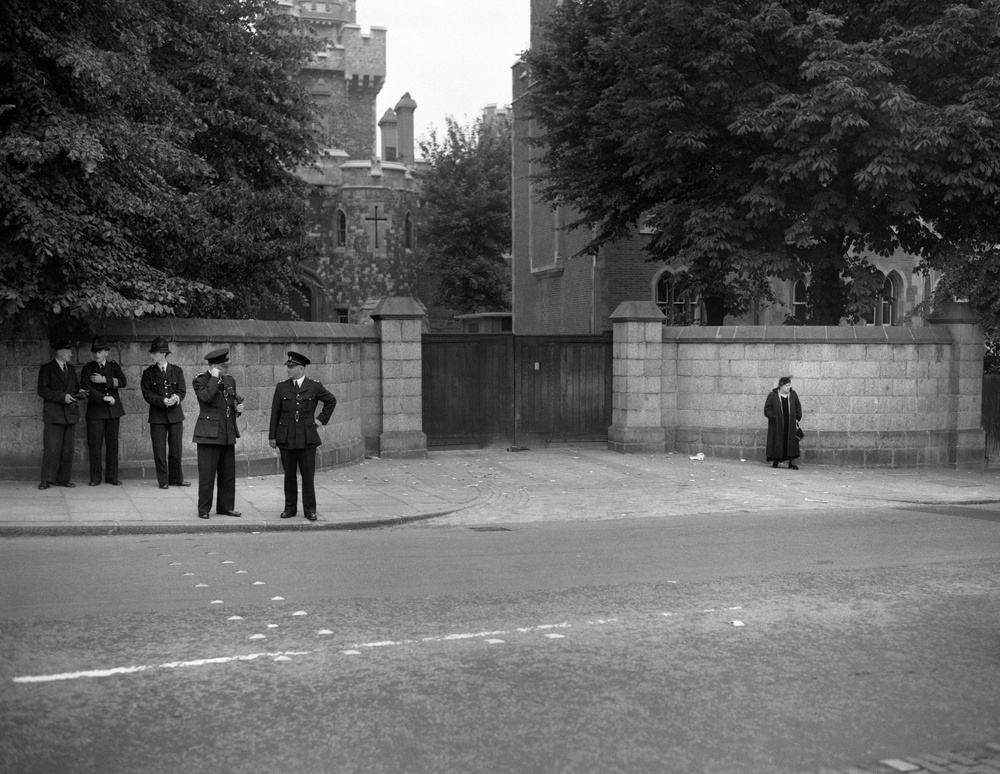 Mrs Violet Van Der Elst, for years an active campaigner against capital punishment, stands apart from police officers outside Holloway Priosn in North London, on the day Ruth Ellis was hanged for the murder of David Blakely (Archive/PA) (PA Archive)