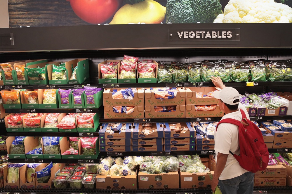 A customer shops for bagged lettuce at a grocery store in Chicago, Illinois, in June 2017. Bagged lettuce and other produce is tied to the spread of cyclospora (Getty Images)