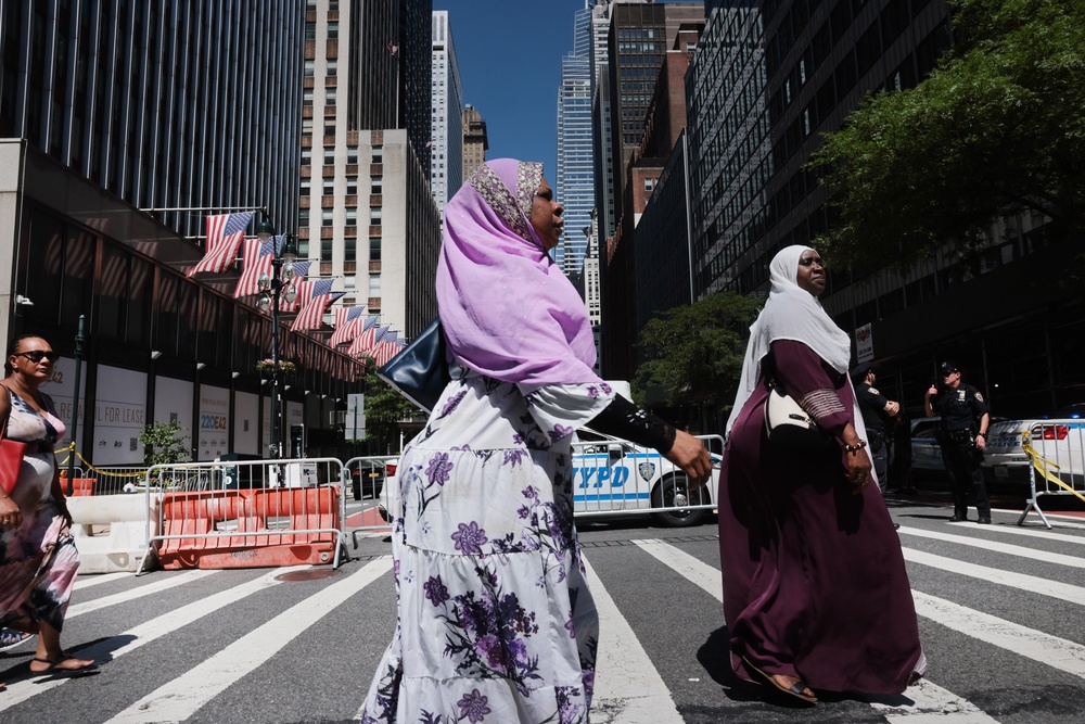 Two women walk past a closed section of 42nd Street beside the former Pfizer headquarters building Wednesday (Getty Images)