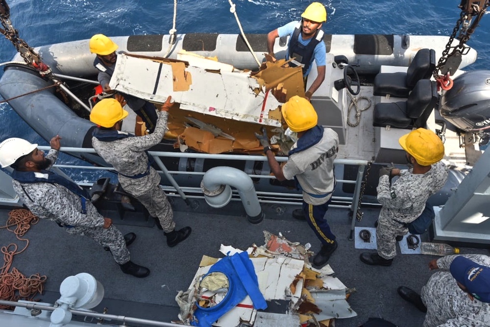 Pakistan Navy personnel shift the wreckage of a cargo plane of the private carrier K2 Airways into a naval ship (Pakistan Navy via AP)