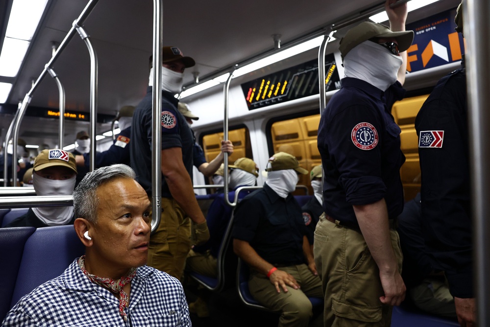 Roswell Encina, a Filipino-American immigrant who was pictured sharing a Metro train with the masked extremists, said the moment prompted him to think about ‘the promise of America and the work still required to protect it’ (Getty)