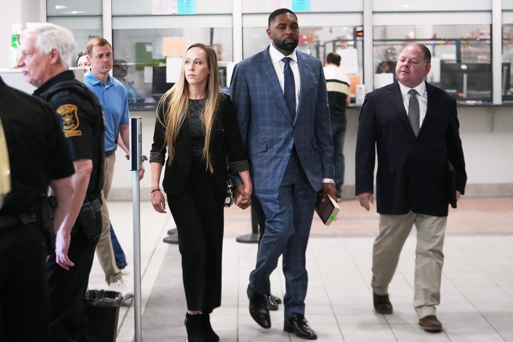 Former Michigan football coach Sherrone Moore and his wife Kelli Moore leave court, April 14, 2026, in Ann Arbor (Copyright 2026 The Associated Press. All rights reserved)