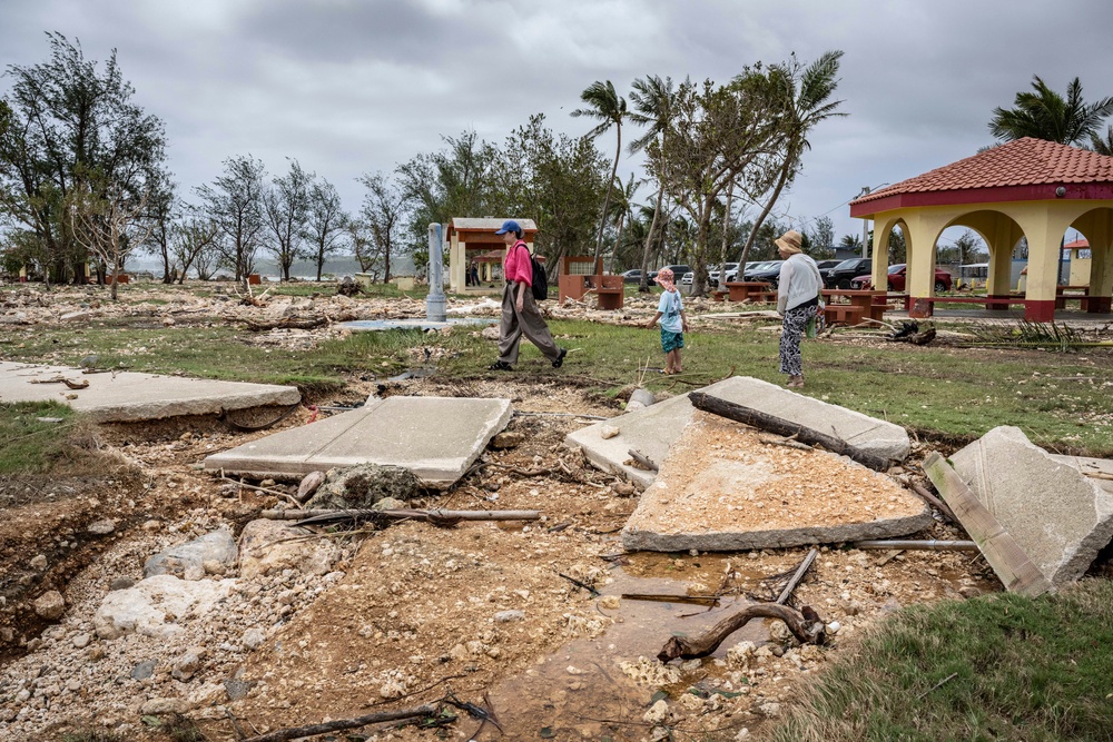 People walk past a damaged walkway at a park in the aftermath of Super Typhoon Bavi in Guam (AFP/Getty)