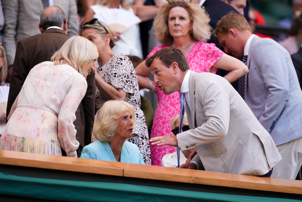Queen Camilla speaks with Peter Phillips and Deborah Jevans in the royal box (PA)