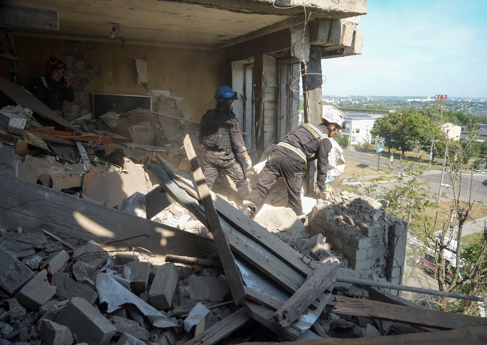 Emergency responders inspect the site of an apartment building hit by a Russian missile strike, amid Russia's attack on Ukraine, in Kharkiv, Ukraine July 8, 2026. (Reuters)