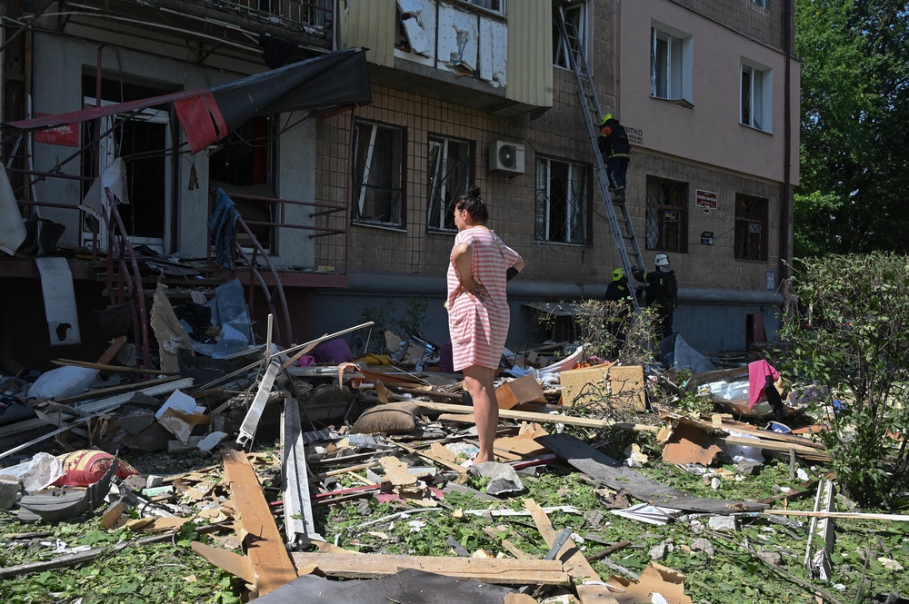 A local resident stands in front of a multistorey residential building damaged following a Russian missile strike in Kharkiv on July 8, 2026, amid the Russian invasion in Ukraine. (AFP/Getty)
