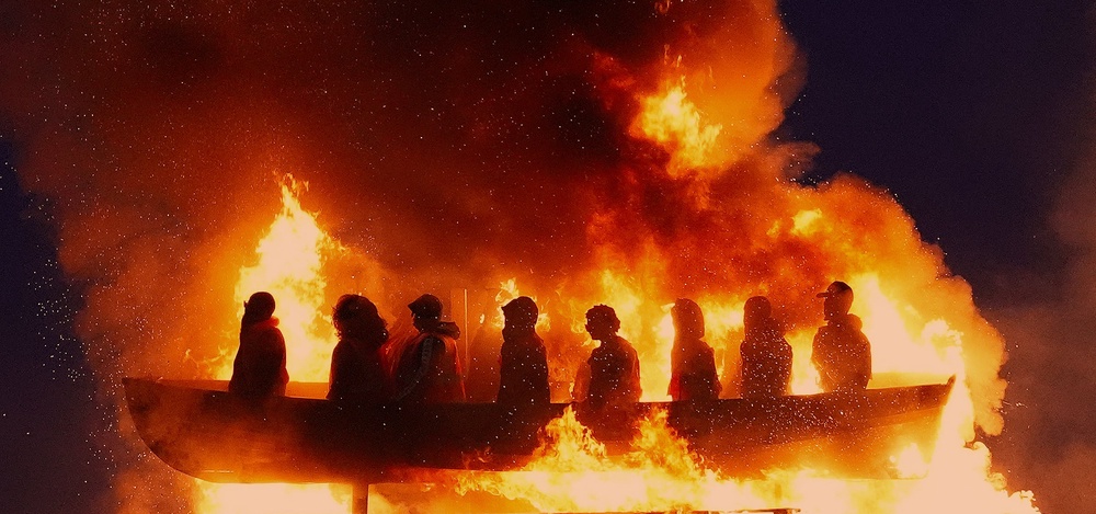 Effigies of migrants in a boat burning on a bonfire in Moygashel last year (Niall Carson/PA) (PA Archive)