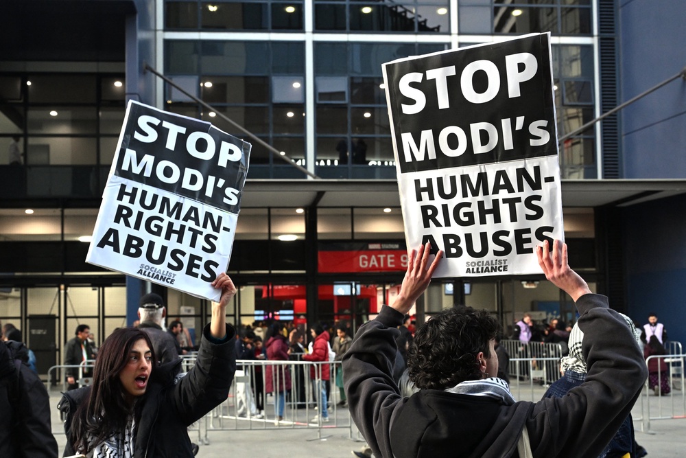 Narendra Modi’s critics shout slogans and hold placards outside a venue for a community event where the Indian prime minister is set to speak at Docklands Stadium in Melbourne on 9 July 2026 (AFP/Getty)