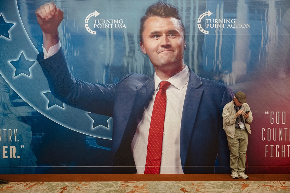 An attendee waits for the start of Turning Point's annual AmericaFest conference, in remembrance of late right-wing political activist Charlie Kirk, in Phoenix (AFP/Getty)