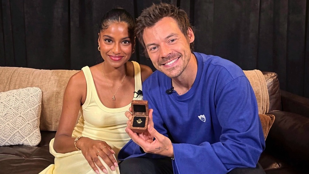Blue Peter presenter Shini Muthukrishnan presenting Harry Styles with a Blue Peter badge. (PA)