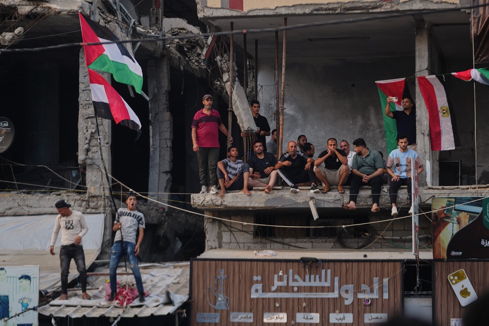 Palestinians watch a live broadcast of the World Cup round of 16 soccer match between Argentina and Egypt in Nuseirat, Tuesday, July 7, 2026 (AP)
