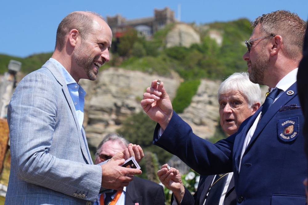 William receives a silver winkle as he meets with members from the charity organisation the Winkle Club (Gareth Fuller/PA) (PA Wire)