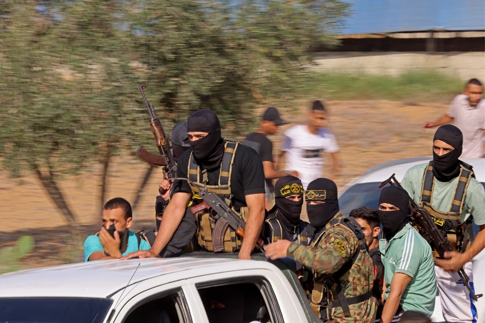 Palestinian militants move towards the border fence with Israel from Khan Yunis in the southern Gaza Strip on October 7, 2023. (AFP via Getty Images)