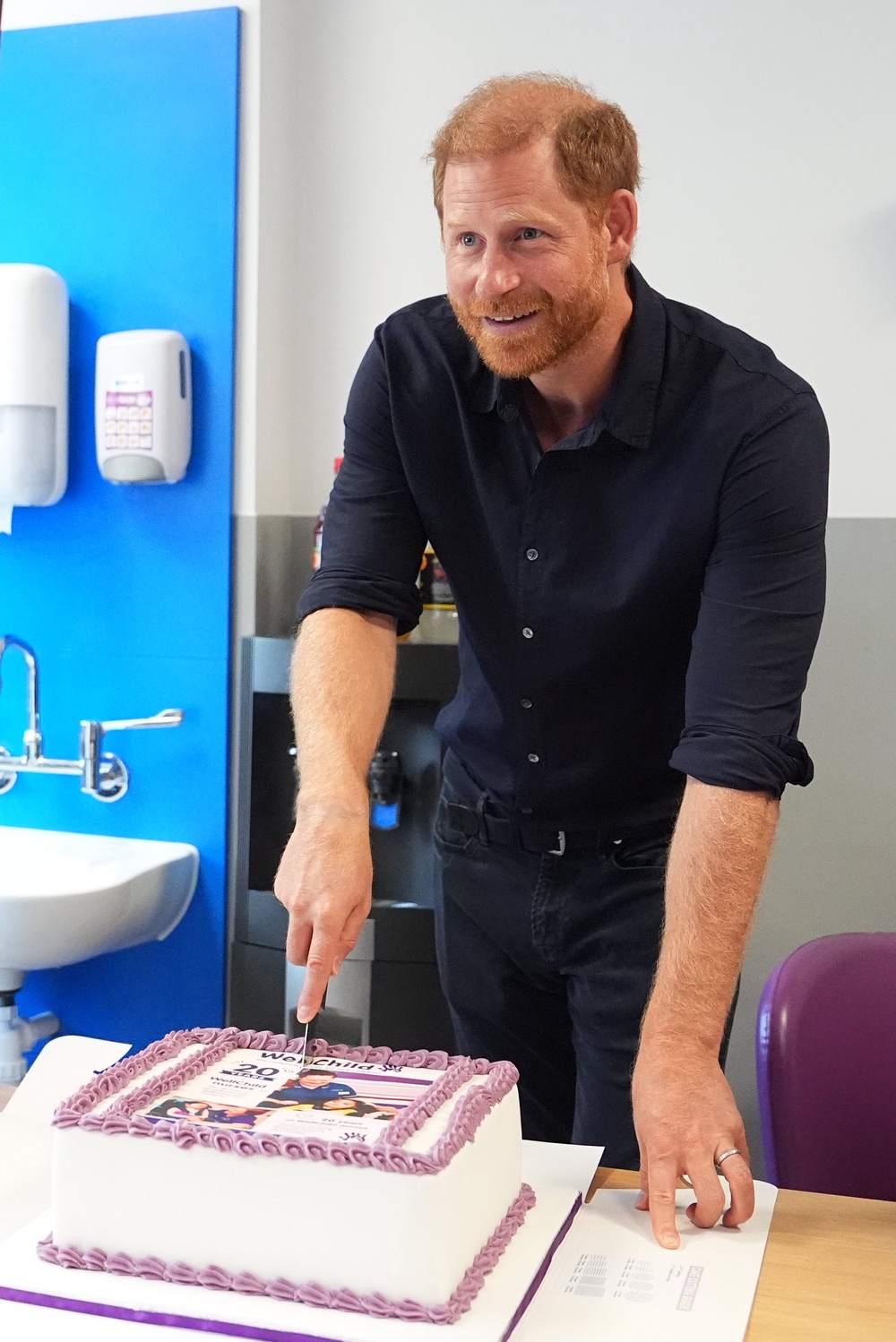 Harry cuts a cake celebrating 20 years of the WellChild programme (Aaron Chown/PA) (PA Wire)