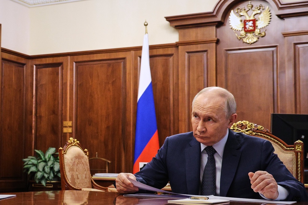 Russian president Vladimir Putin listens to President of the Russian Chamber of Commerce and Industry Sergei Katyrin at the Kremlin in Moscow (AP)