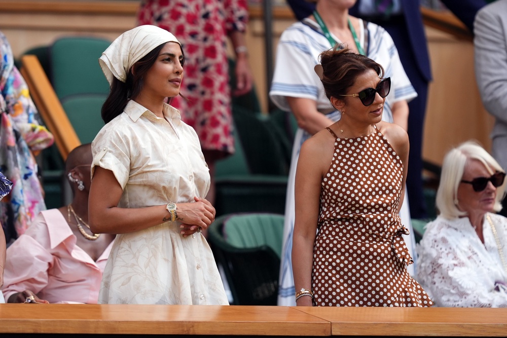 Priyanka Chopra Jonas, left, in the royal box on day 11 (PA)