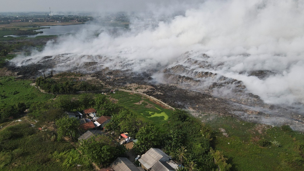 A drone view shows smoke billowing from burning garbage at the Jatiwaringin landfill site (Reuters)