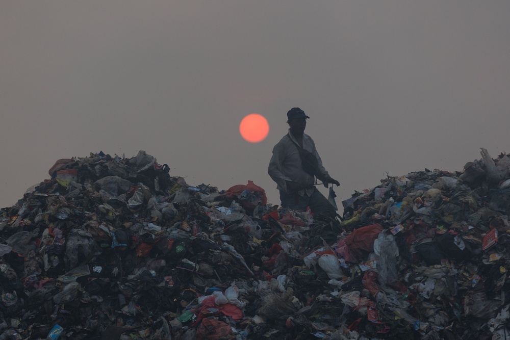 A ragpicker sorts through garbage as smoke billows from a fire at the Jatiwaringin landfill in Tangerang (AFP/Getty)
