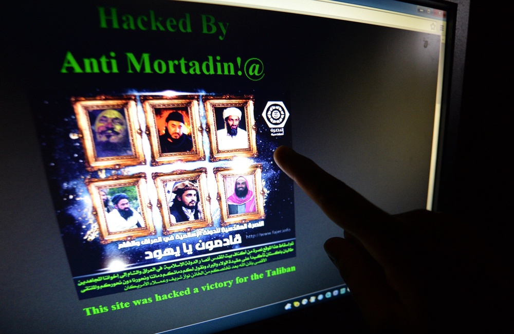A Pakistani points at a computer screen showing the hacked official website of Rawalpindi police displaying pictures of slain Al-Qaeda leader Osama bin Laden bin (top R) and former leaders of Pakistani Taliban Baitullah Mehsud (L bottom) and Hakimullah Mehsud (C bottom), both killed in two separate US drone attacks, in Islamabad (AFP/Getty)