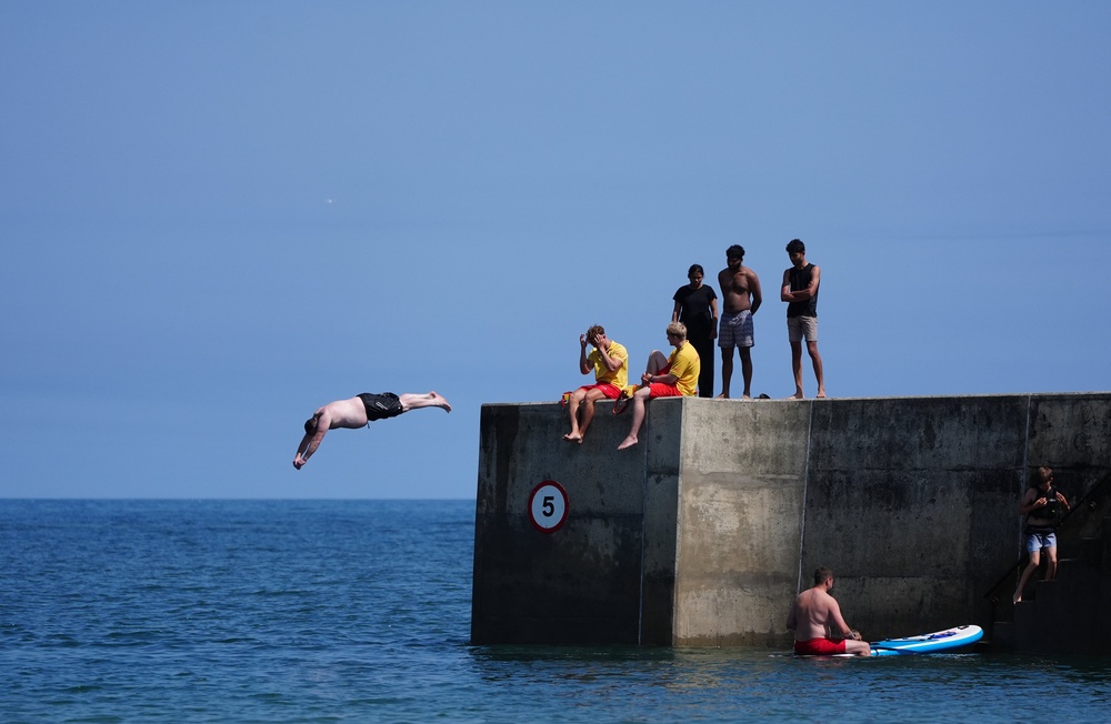People diving from the seawall at Cullercoats Bay in North Tyneside (Owen Humphreys/PA) (PA Wire)