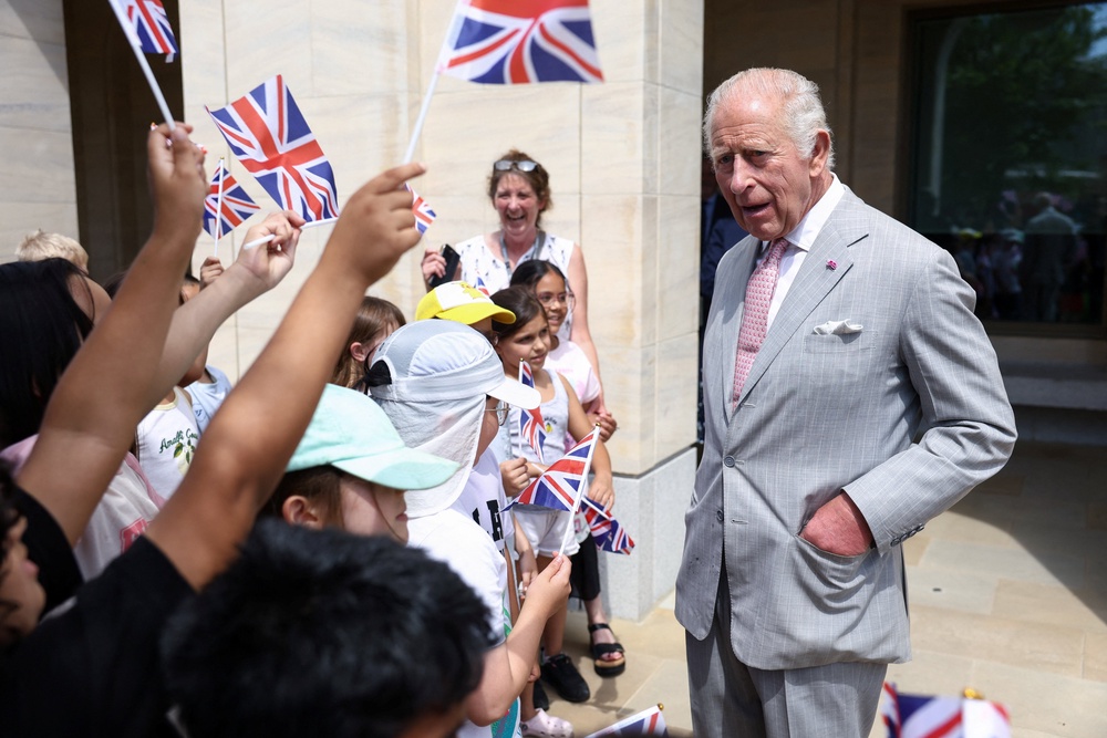 The King speaks with children as he departs the Stephen A Schwarzman Centre for Humanities (Toby Shepheard/PA) (PA Wire)