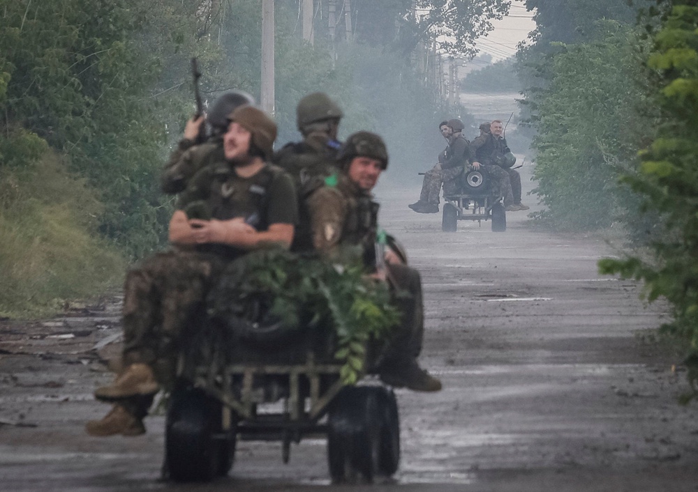 Ukrainian servicemen ride unmanned ground vehicles (UGV) during their combat mission, amid Russia's attack on Ukraine, in the frontline town of Druzhkivka, in Donetsk region, Ukraine July 9, 2026. (Reuters)
