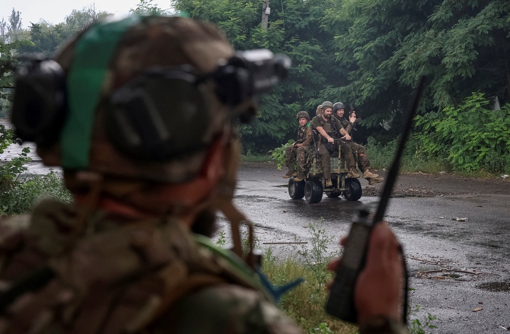 Ukrainian servicemen ride an unmanned ground vehicle (UGV) during their combat mission, amid Russia's attack on Ukraine, in the frontline town of Druzhkivka, in Donetsk region, Ukraine July 9, 2026. (Reuters)