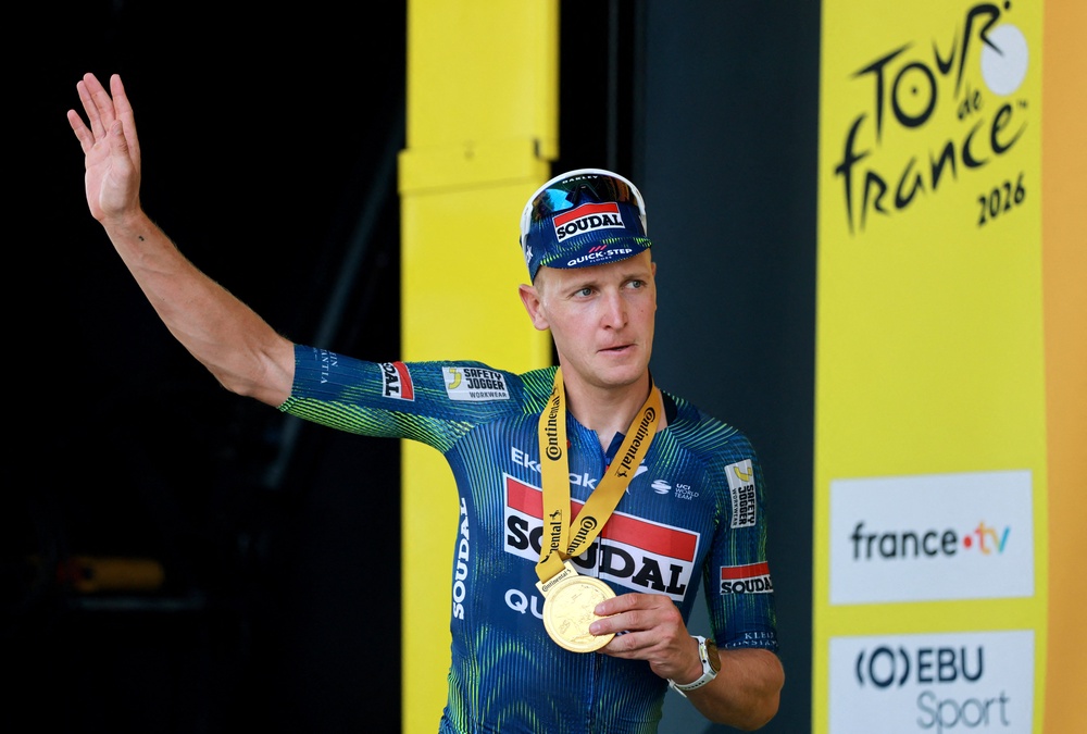 Tim Merlier celebrates his stage-seven win (Reuters)
