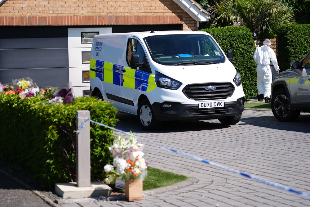 Forensic investigators at a house in Great Denham, near Bedford, where they found the bodies of the mother and two children (Jacob King/PA) (PA Wire)