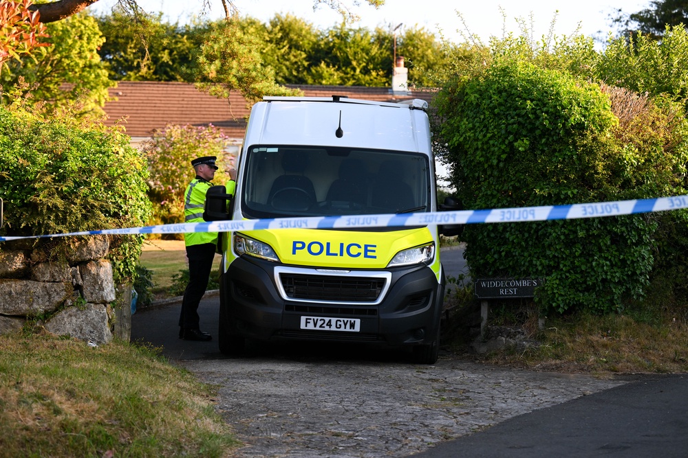 A police officer stands outside the house of Ann Widdecombe in Haytor on July 11 (Getty)