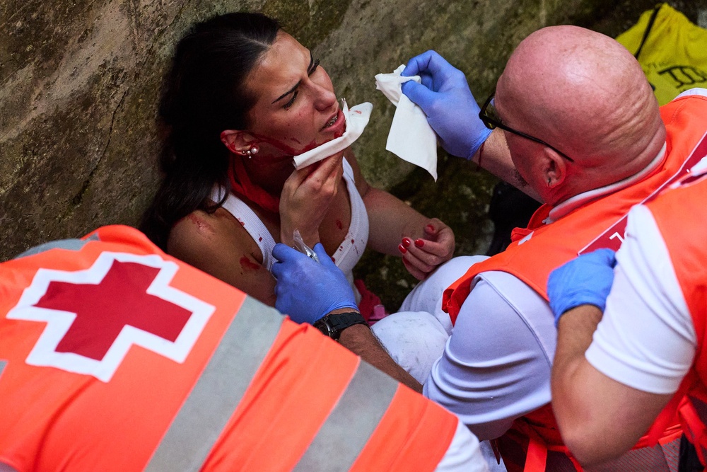 Doctors work on someone injured at the running of the bulls (AP)