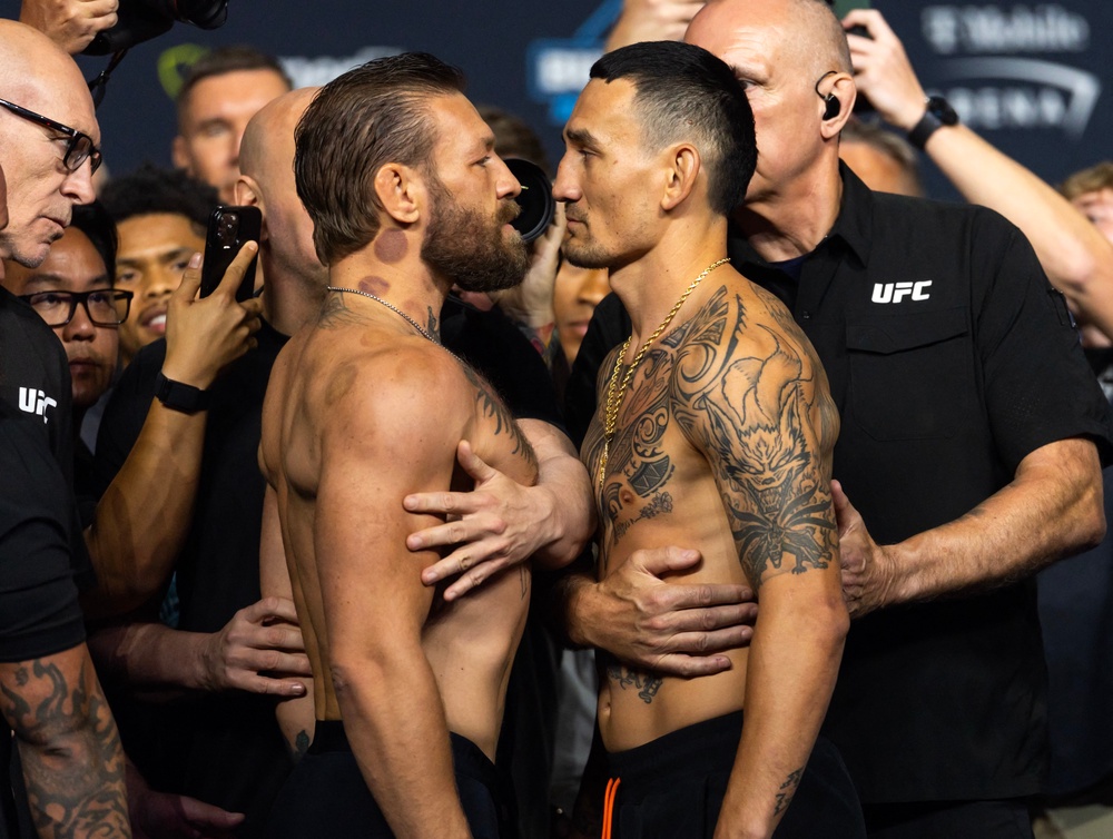 Conor McGregor (left) faces off with Max Holloway during weigh ins (Reuters)