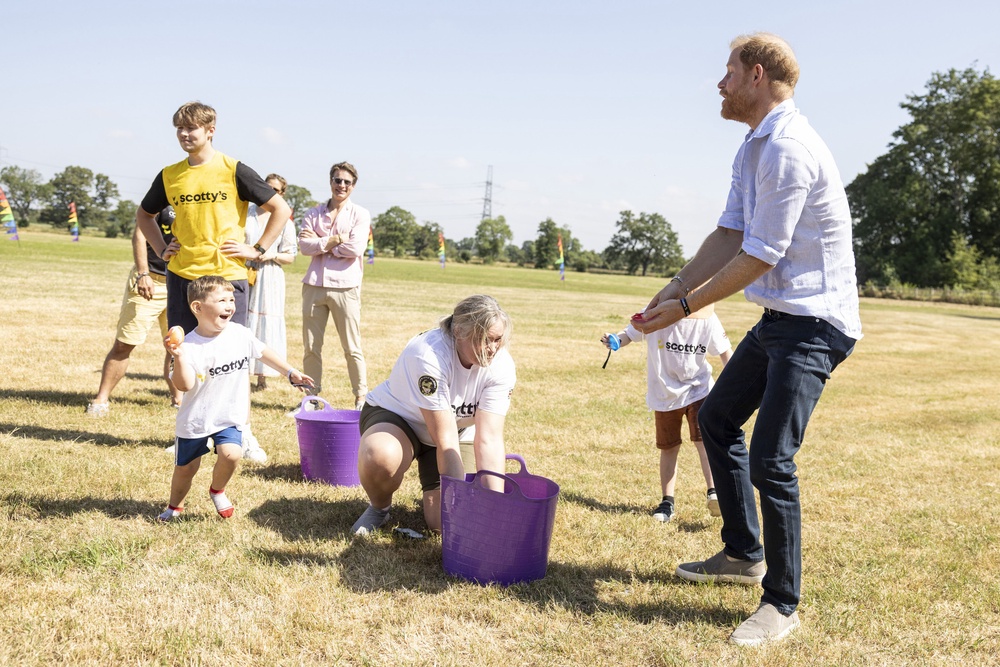 Harry dodged water balloons thrown by the children (Heathcliff O’Malley/Daily Telegraph/PA) (PA Wire)
