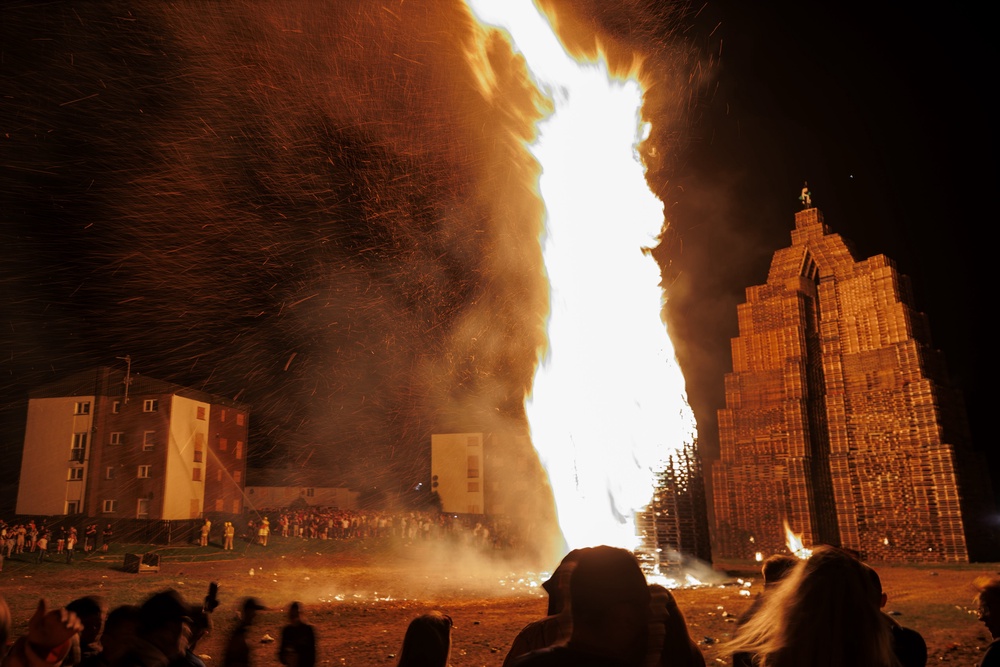 Members of the public watch one of the two Loyalist Corcrain Redmanville (LCR) bonfires in Portadown as part of the Twelfth of July celebrations (Liam McBurney/PA) (PA Wire)