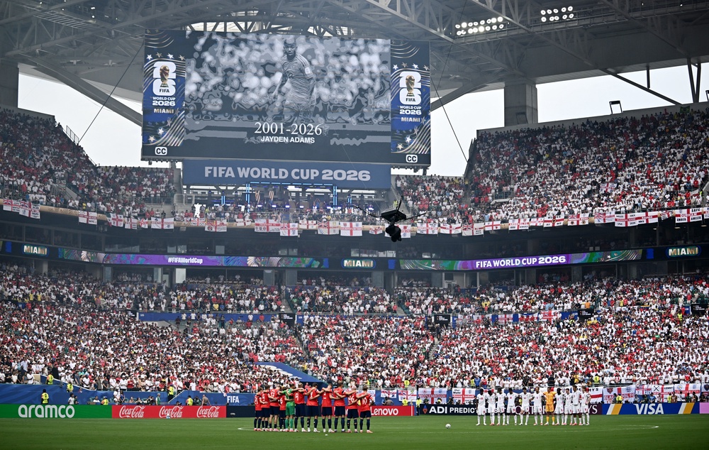 The players stand during a minutes silence in memory of South African's Jayden Adams before the match (Reuters)