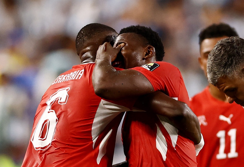 Switzerland's Denis Zakaria consoles Breel Embolo with after he is shown a second yellow card and red card (Reuters)