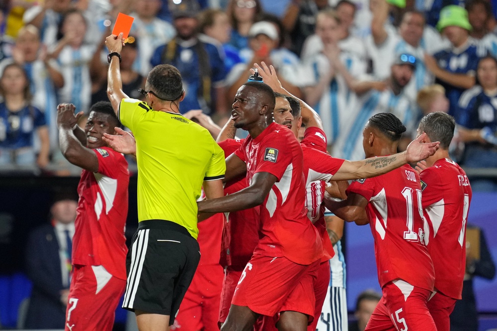 Referee Joao Pinheiro, of Portugal, gives a red card to Switzerland's Breel Embolo (AP)