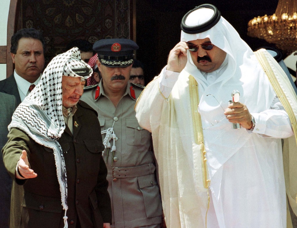 Palestinian president Yasser Arafat receives Sheikh Hamad bin Khalifa al-Thani during the first visit of a Gulf Arab head of state to Gaza on 8 August 1999 (Reuters)