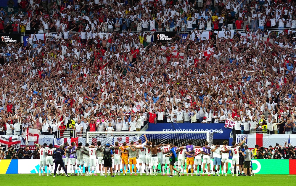 England players line arms as the England fans sing and celebrate following victory on Saturday (PA)