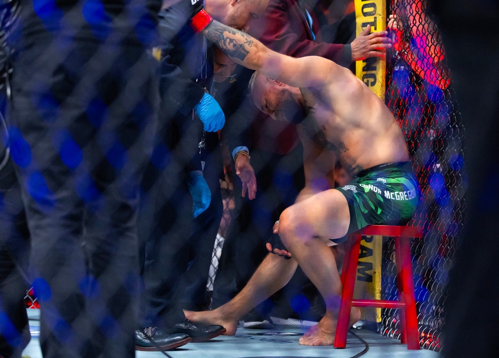Conor McGregor reacts after suffering an injury the ended his fight with Max Holloway (Reuters)