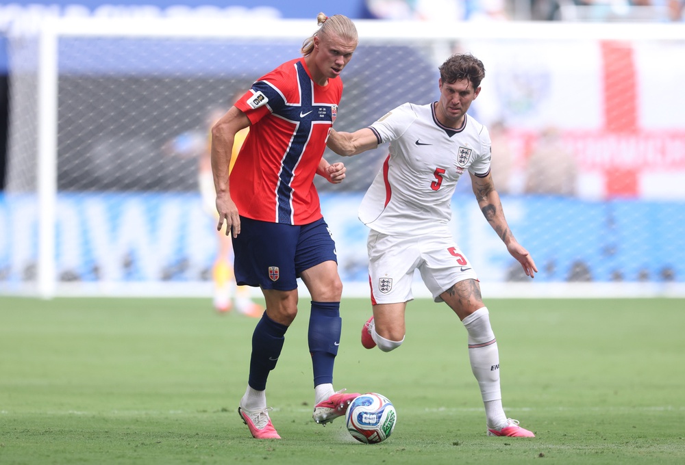 Erling Haaland #9 of Norway and John Stones #5 of England on Saturday (Getty)
