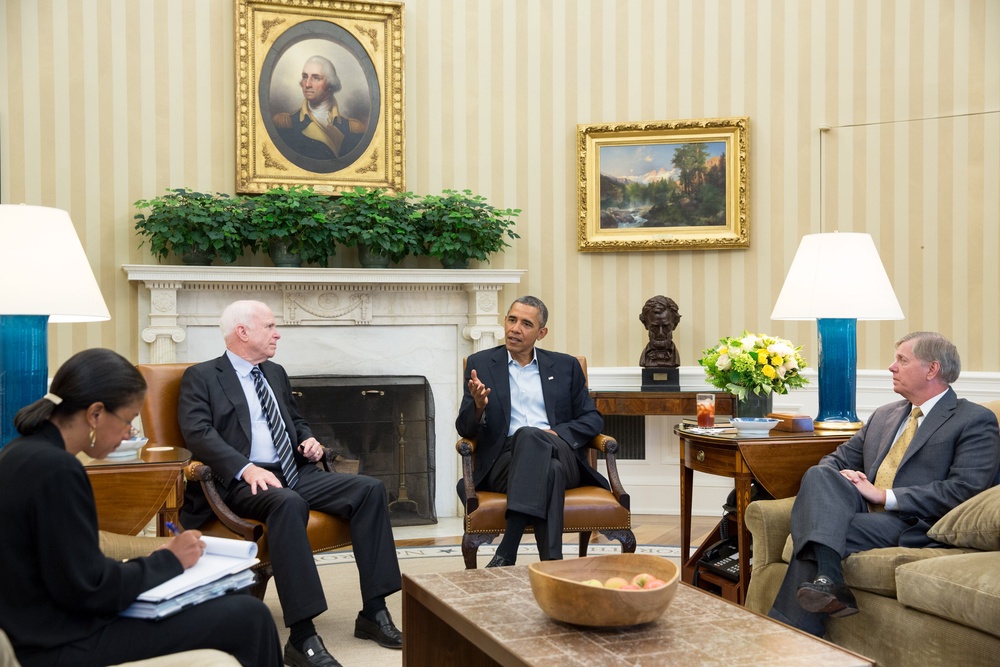 Graham and fellow GOP senator John McCain sit down with then-president Barack Obama in the Oval Office in 2013 to discuss strategy in Syria (Getty)