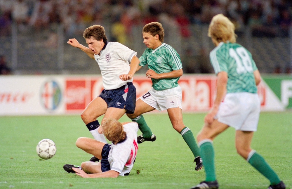 England players Mark Wright (floor) and Peter Beardsley combine to thwart Olaf Thon of West Germany during the 1990 FIFA World Cup Semi Final (Getty)