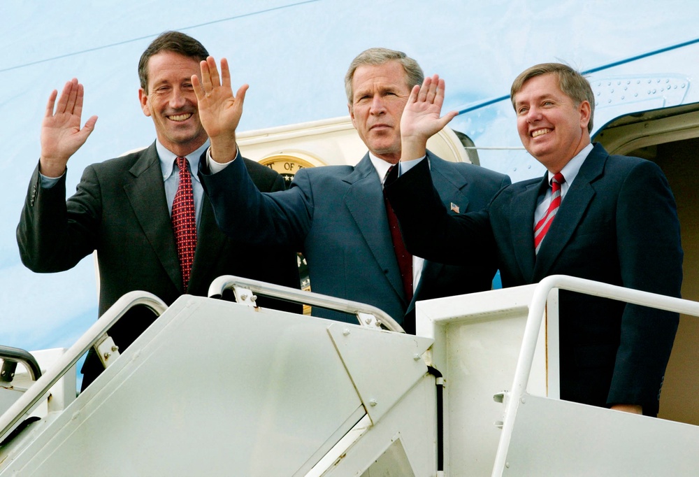 Graham joins former president George W Bush and South Carolina gubernatorial candidate Mark Sanford in his home state in 2002 (AFP/Getty)