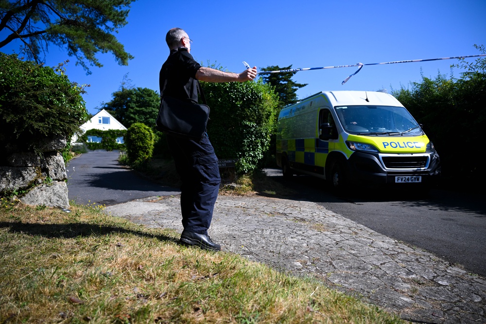 A police officer stands outside the house of Ann Widdecombe in Haytor on Saturday (Getty)