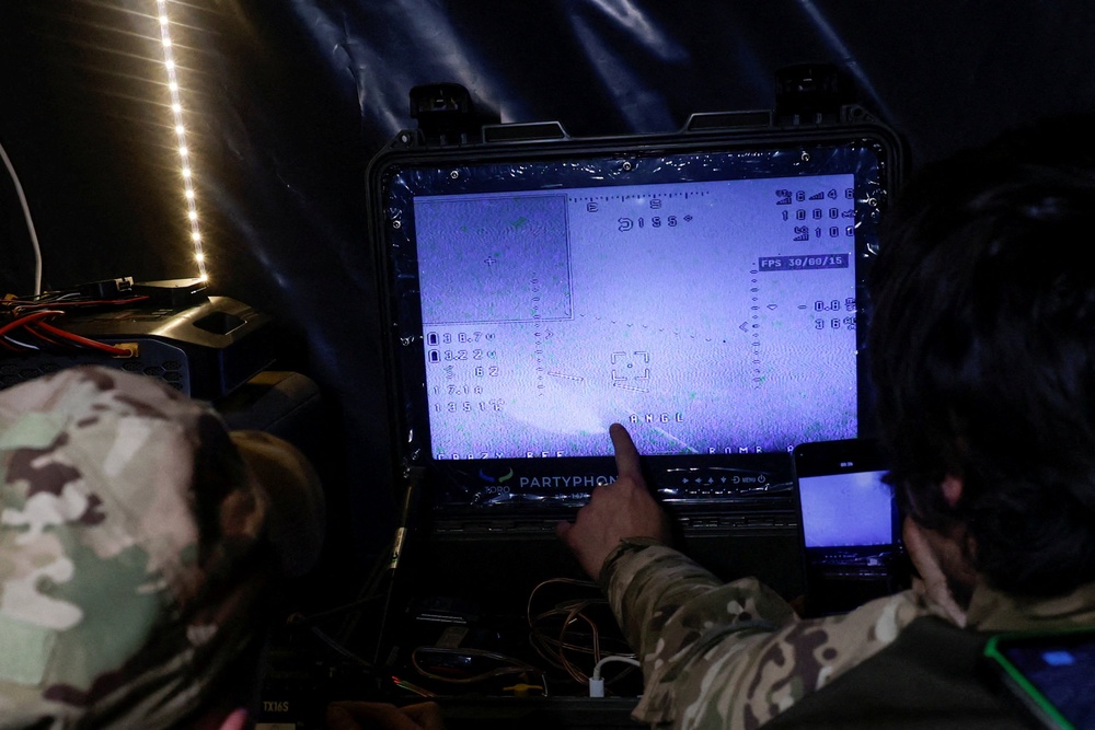 Servicemen of the 66th Separate Mechanized Brigade named after Prince Mstyslav the Brave control a Darts middle range strike unmanned aerial vehicle which flies toward Russian troops in a front line (Reuters)