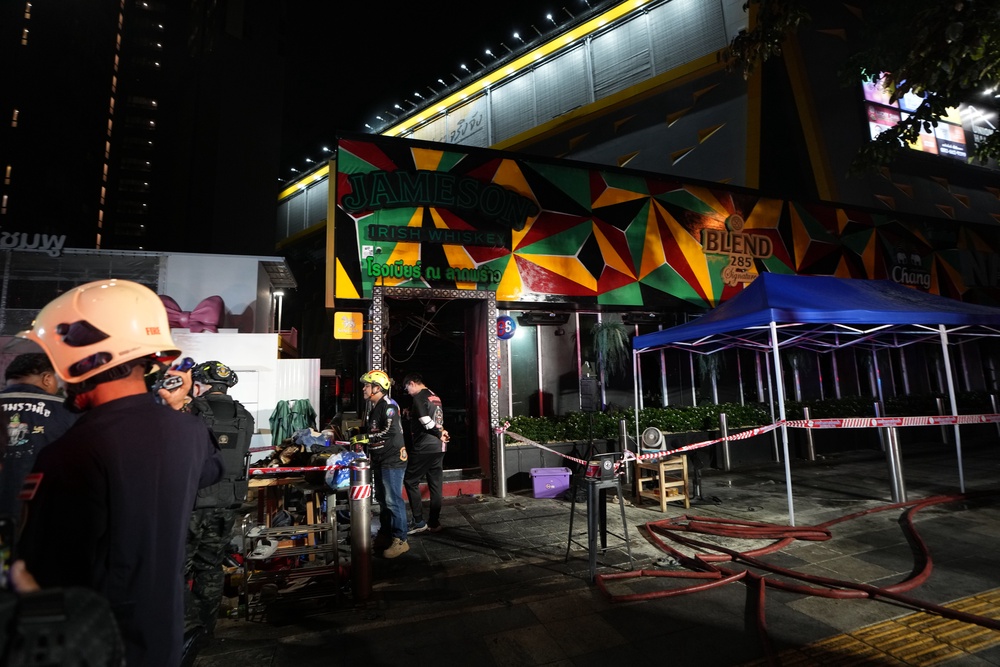 Rescuers outside the Rong Beer Na Lat Phrao bar (AP)